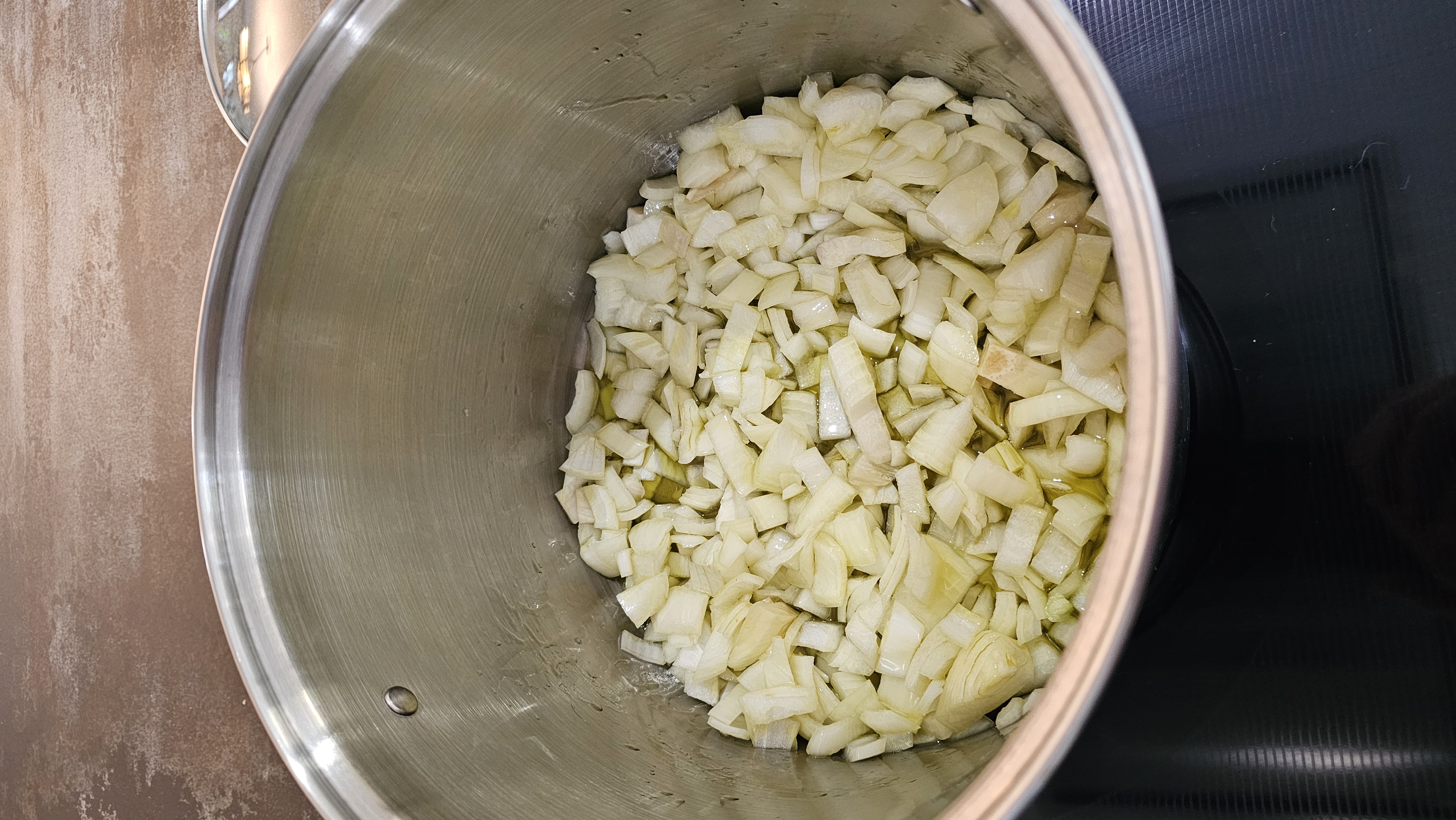 chopped onions in a pot with oil